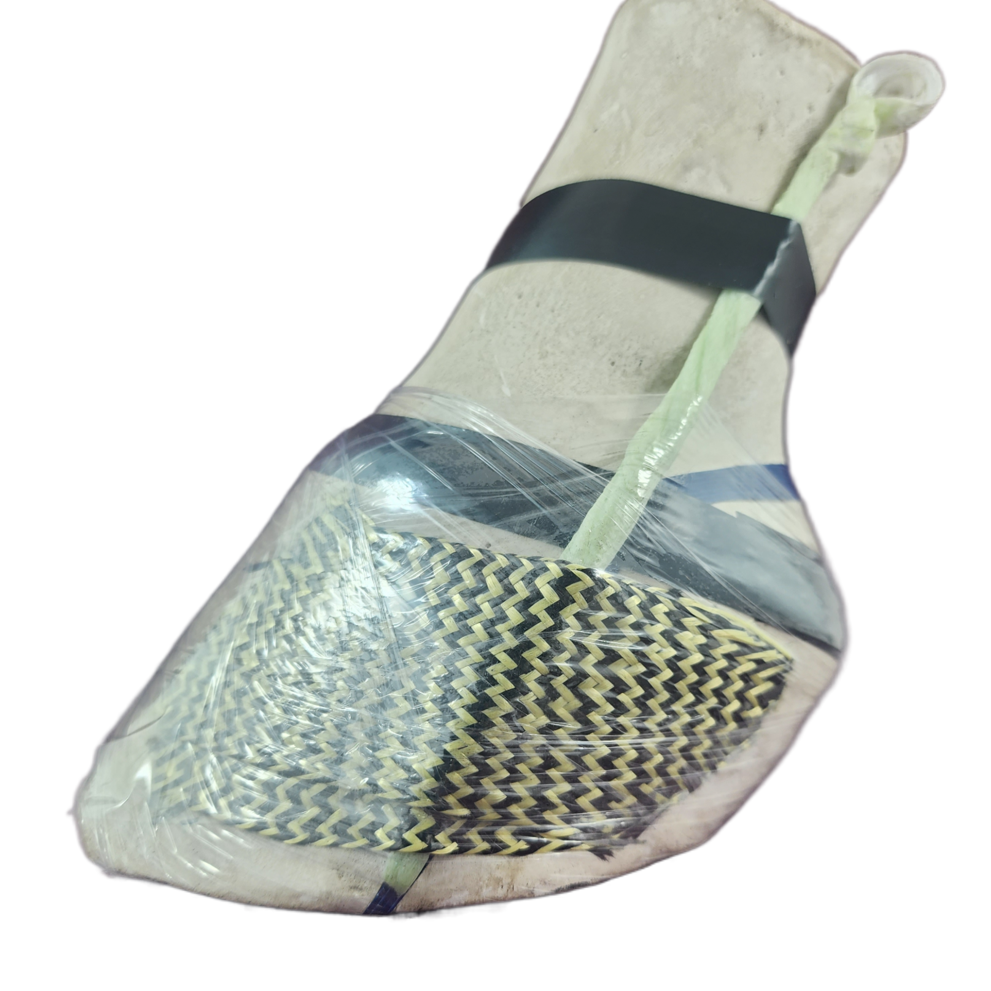 Doc's Sticky Lace Patch Drain in place beneath a kevlar patch demonstration, displaying it being secured with a single piece of tape until the acrylic is set and the drain 'spacer' can be removed by simply pulling upwards.