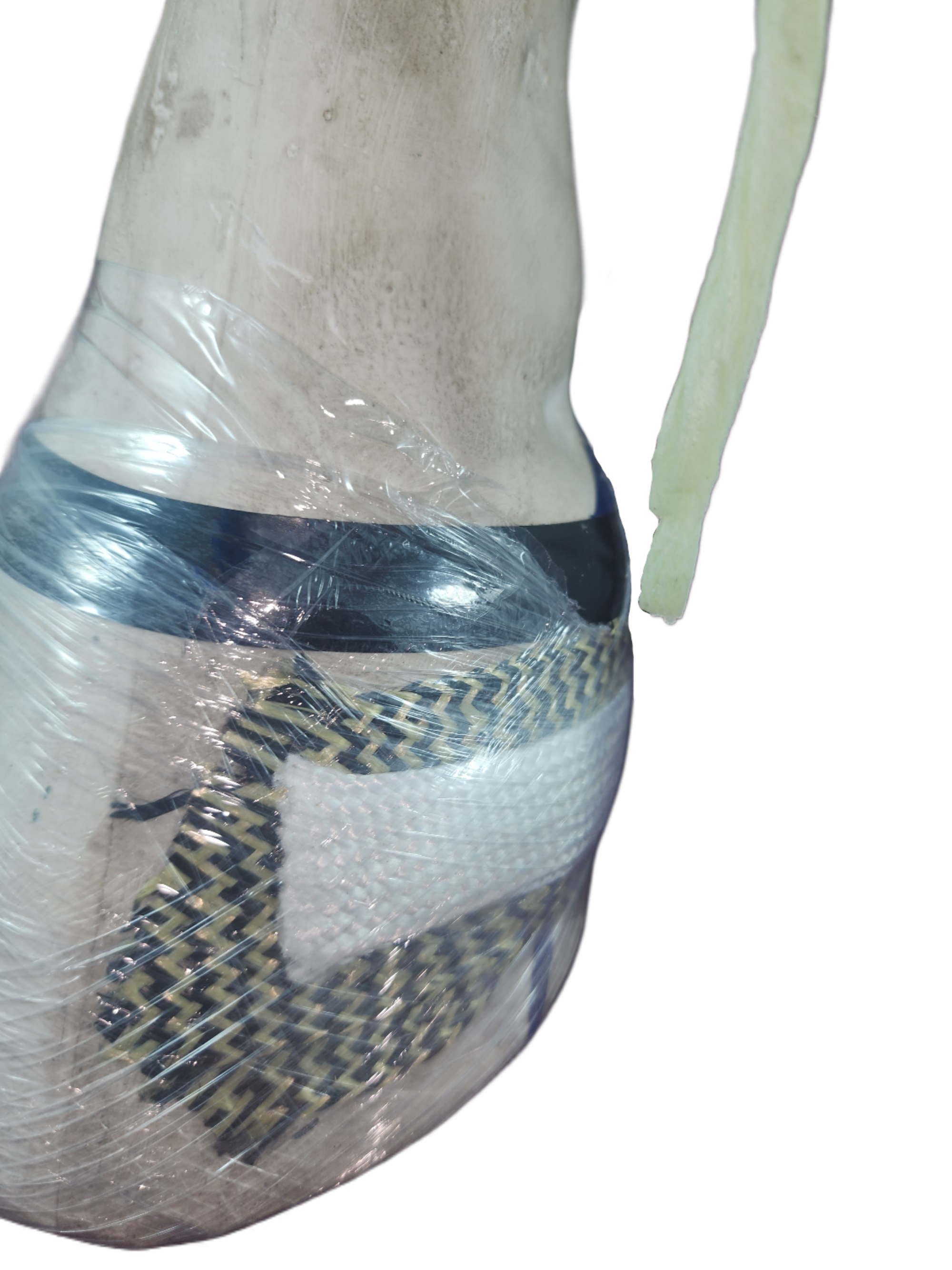 The end of Doc's Sticky Lace is visualized after having just been pulled from behind an acrylic, kevlar & spectra patch where it occupied the space that becomes the drainage portal until the acrylic is cured.  Its job is complete, the drain is formed.