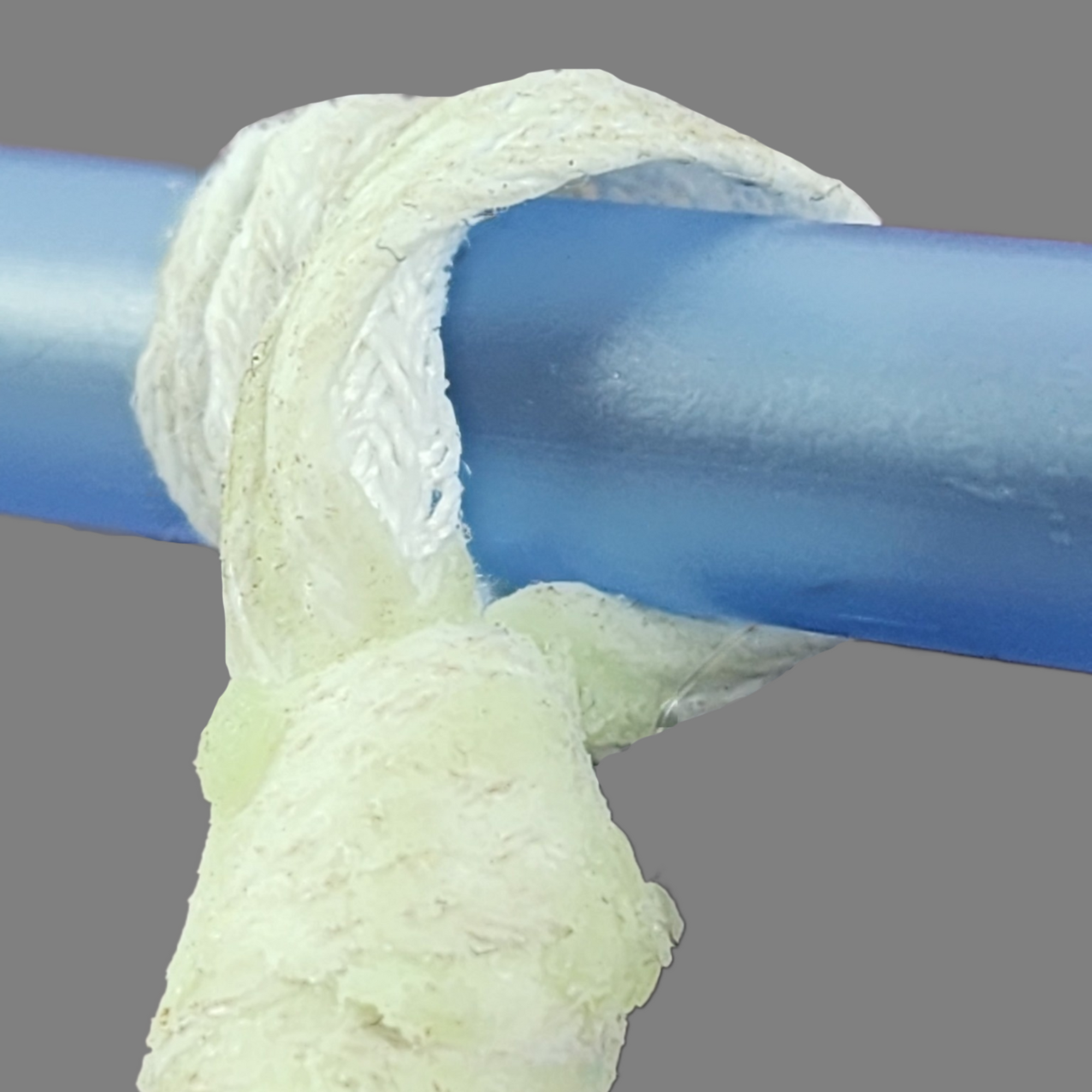 The Extraction Eyelet of Doc's Sticky Lace - Antiseptic Wax coated 4 ply Void-Drain Forming Cord with a  pen placed through it, as would be positioned when a forceful extraction is needed, affording a secure pulling handle. -  A Canadian Forge Specialty Product.