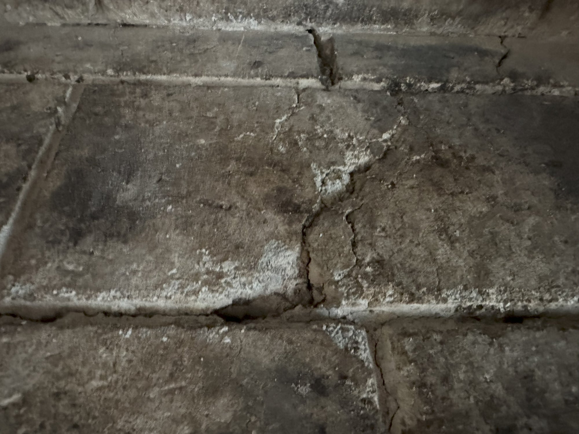 Closeup of a cracked fireplace / wood stove refractory brick panel to be replaced @ Canadian Forge with a custom casting to pass W.E.T.T. Inspections